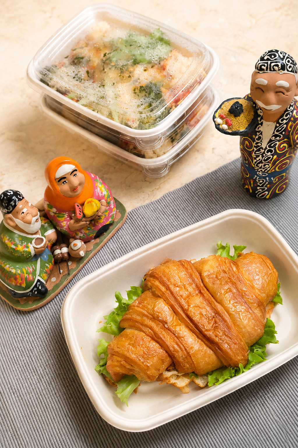 Quisine croissant meal with traditional Uzbek figurines
