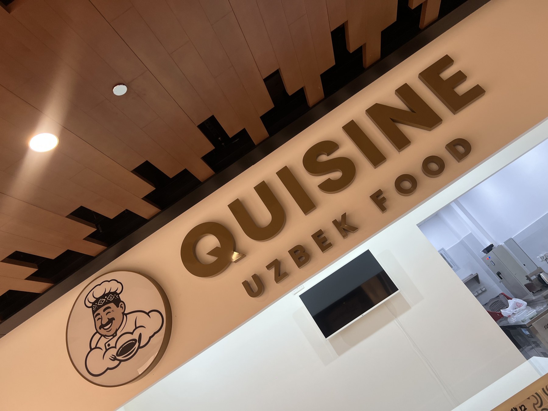 Quisine Uzbek Food storefront sign at City Land Mall, Dubai